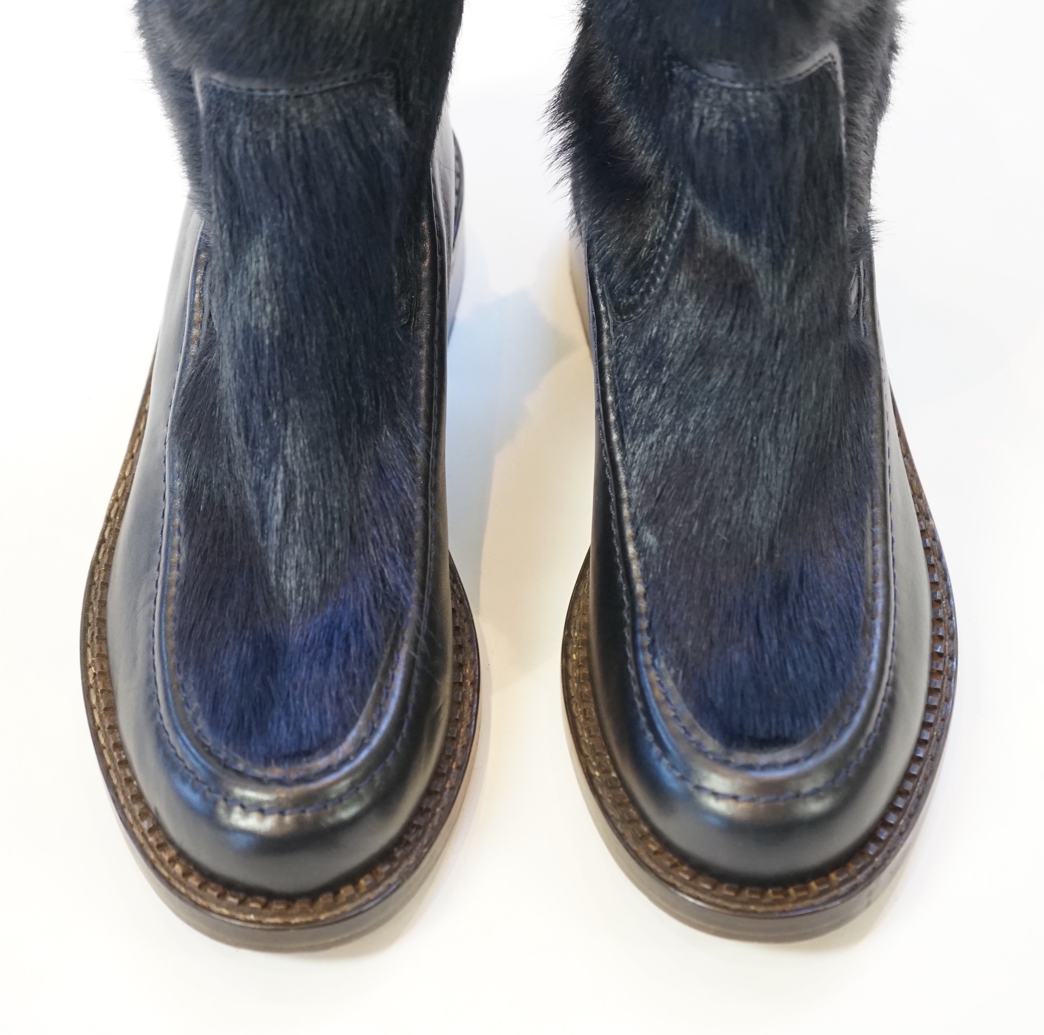 A pair of Chanel lady's navy blue leather calf hair pleated belted buckle boots, size EU 40.5